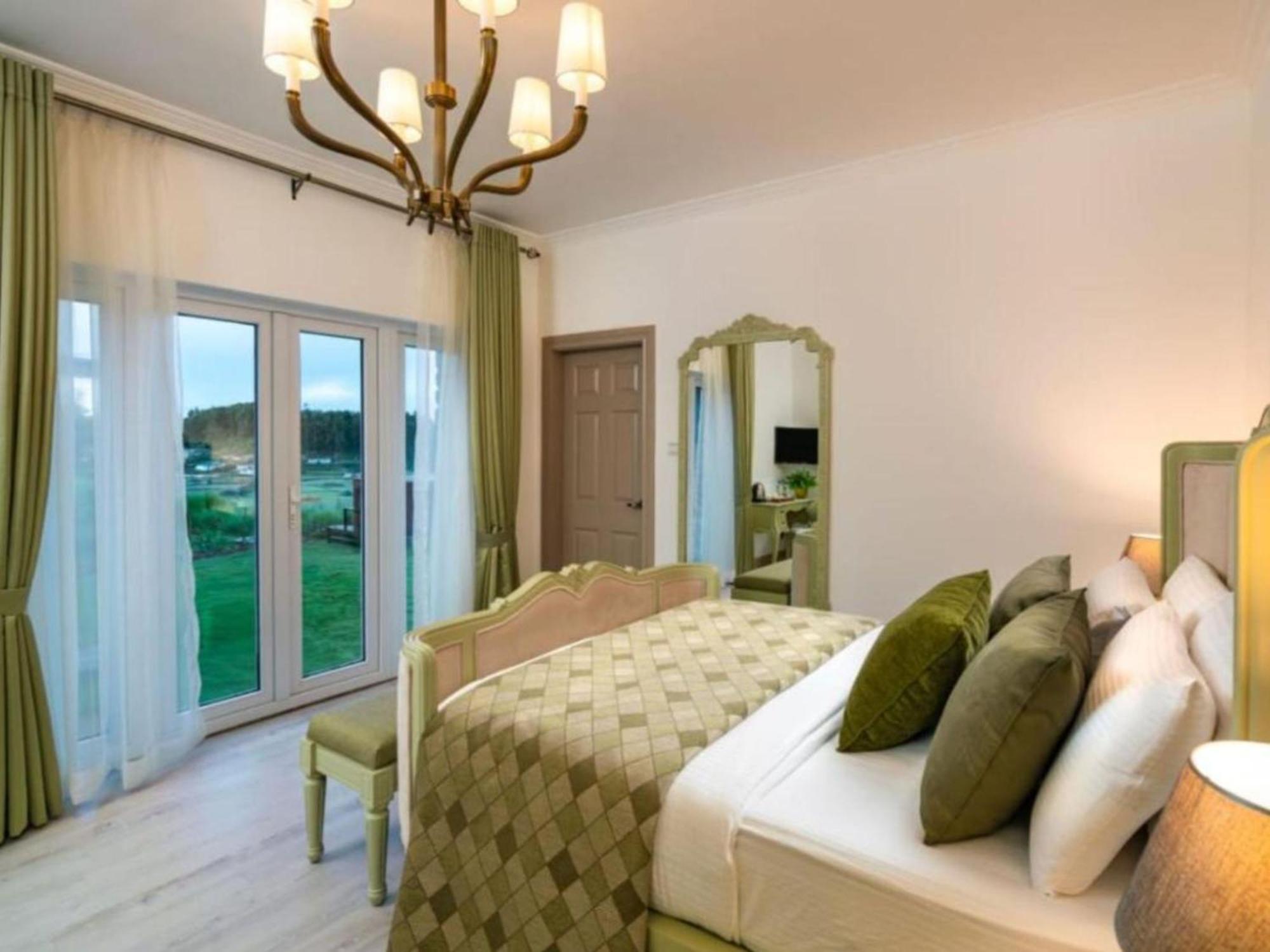 Habitación con cama grande y vistas al jardín